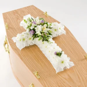 Handcrafted funeral cross flower spray, symbolising faith, love, and eternal life for Christian funerals.