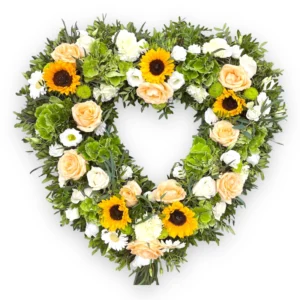 Handcrafted funeral heart tribute with roses and lilies, symbolising eternal love and remembrance.