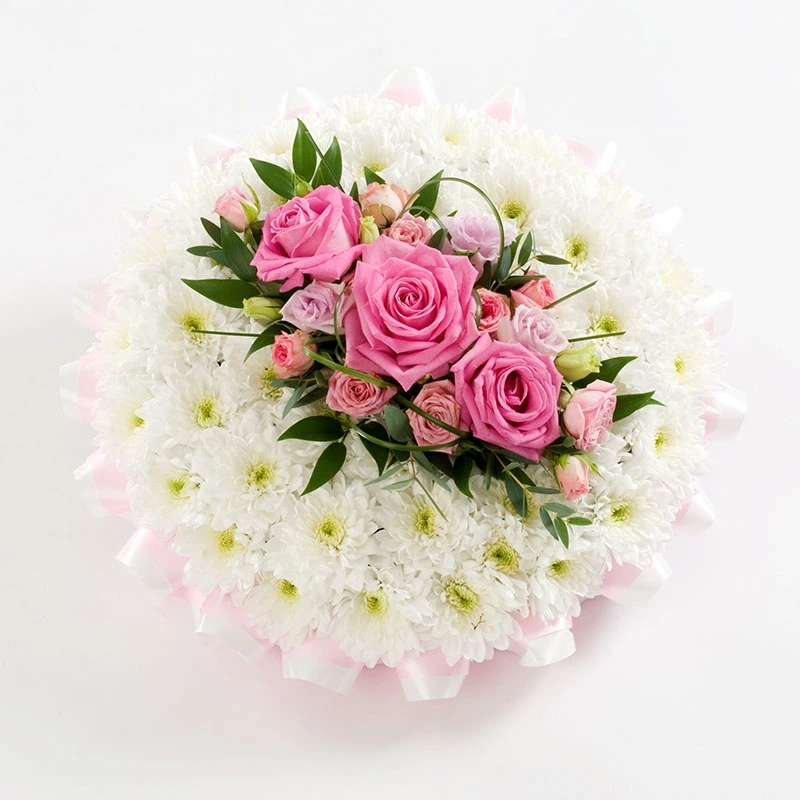 Seasonal funeral posy pad tribute with fresh handcrafted blooms symbolising love, remembrance, and natural elegance